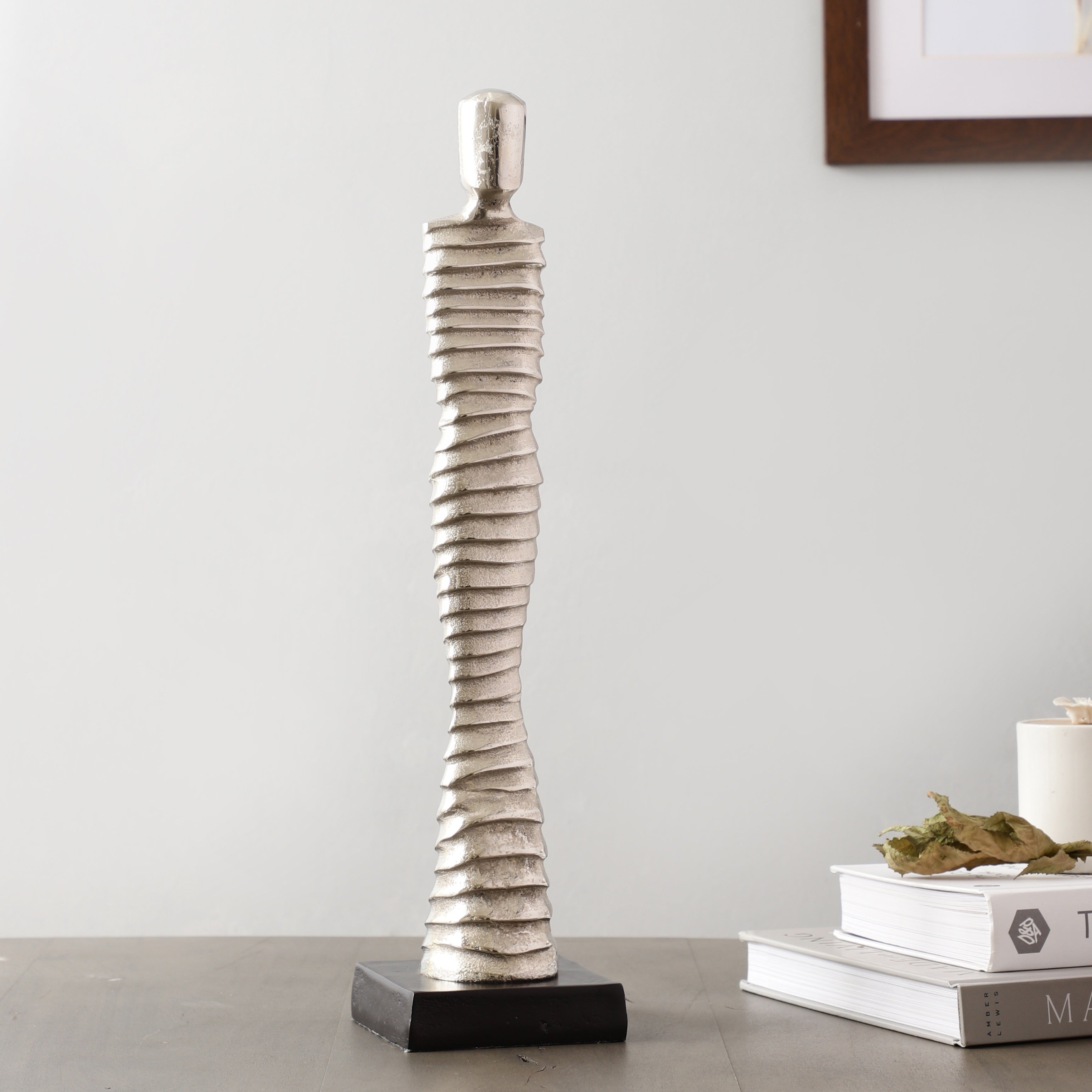 Decorative vase with a unique spiral design on a gray surface.