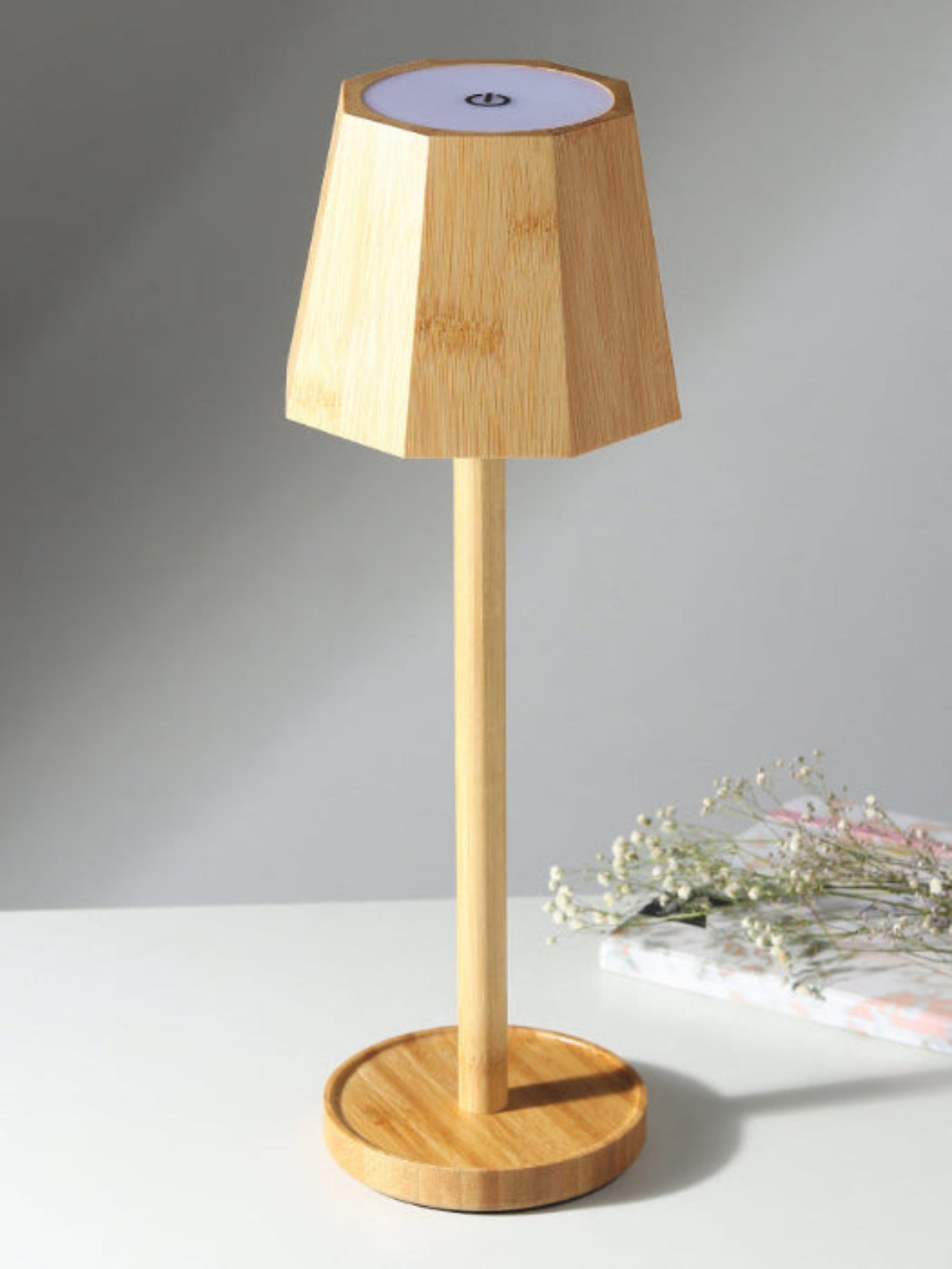 Wooden table lamp with a minimalist design on a gray background